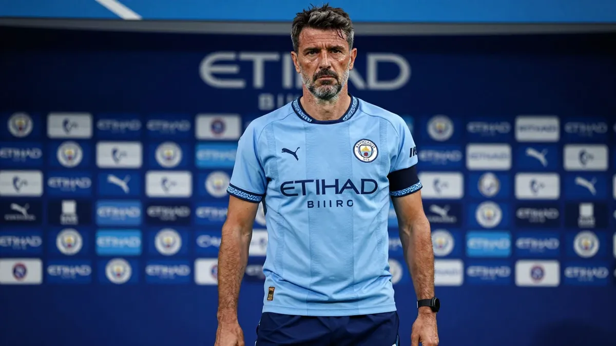 A 35-year-old Portuguese assistant coach with a rugged build, wearing Manchester City's sky blue home shirt with navy...