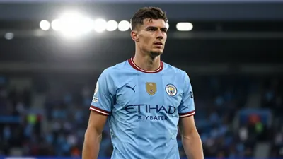 A 22-year-old, tall and lean Manchester City player, with a determined expression, wearing a sky blue jersey...