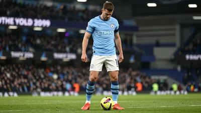 A tight waist-up shot of a 30-year-old Manchester City midfielder in a blue jersey and white shorts, with a determined...