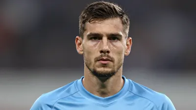 Photorealistic head-and-shoulders shot of a 34-year-old male goalkeeper in a solid light blue jersey, smooth fabric texture