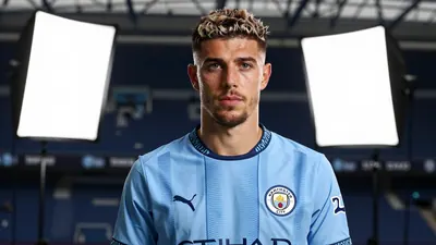 A 30-year-old Manchester City midfielder, with a strong build and determined expression, wearing the sky blue and navy...